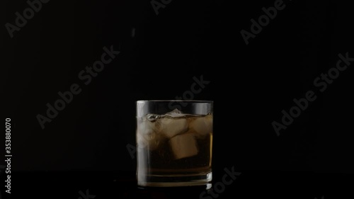 Wallpaper Mural Ice cubes falling in glass with liquor, slow motion 120 fps Torontodigital.ca