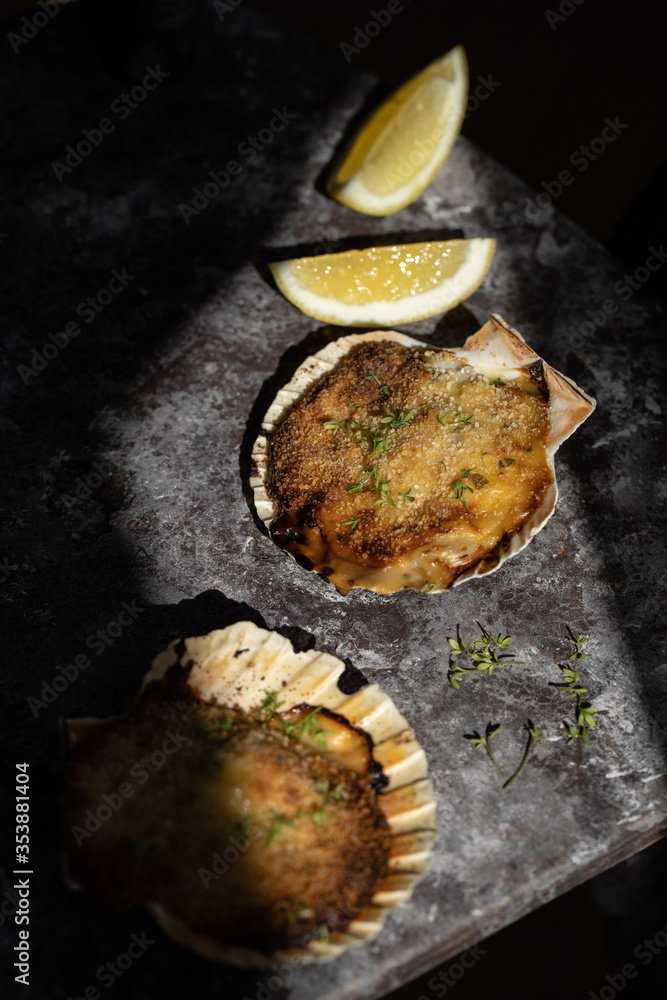 Coquille St Jacques scallop shellfish filled with white wine and cheese cream sauce, topped with breadcrumbs Coquille St Jacques scallop shellfish filled with white wine and cheese cream sauce, topped with breadcrumbs