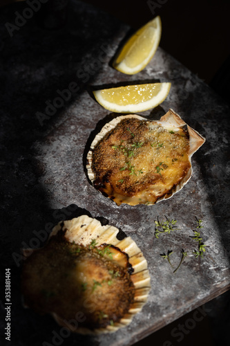 Coquille St Jacques scallop shellfish filled with white wine and cheese cream sauce, topped with breadcrumbs