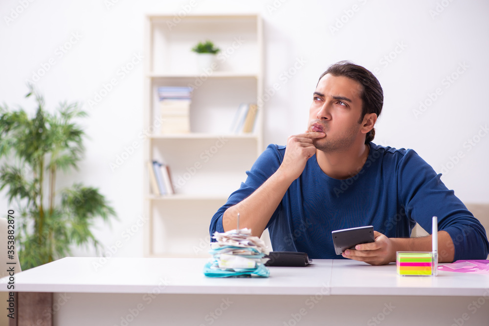 Young man in budget planning concept Young man in budget planning concept