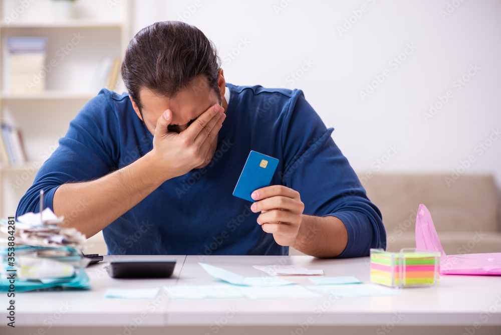 Young man in budget planning concept Young man in budget planning concept