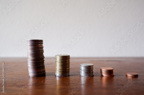 Thai coins and the Glass jar on the wood table with white background for using as background, texing the message information.