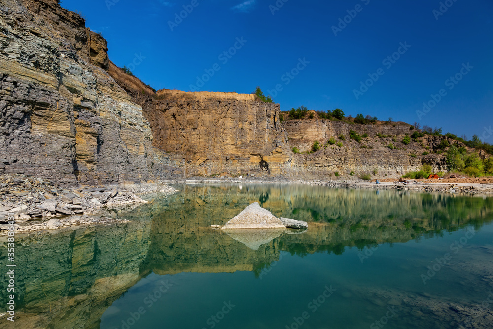 Abandoned granite and sand quarry with a lake. Stone extraction in the canyon.