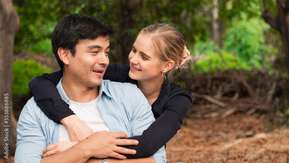Young couple is hugging and sitting close in the park Young couple is hugging and sitting close in the park