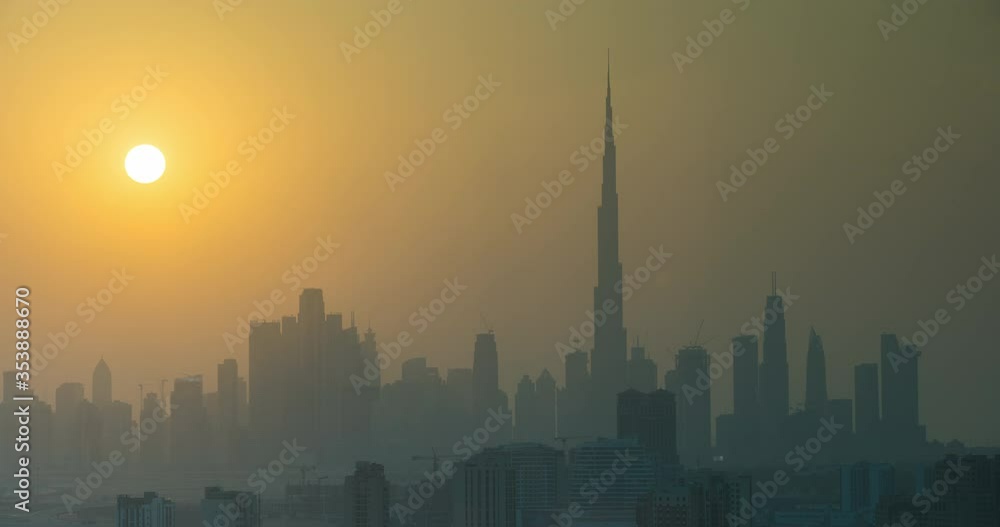 Sunset in Dubai view to downtown, time lapse. Sun sets over the skyscrapers or buildings in modern city Sunset in Dubai view to downtown, time lapse. Sun sets over the skyscrapers or buildings in modern city