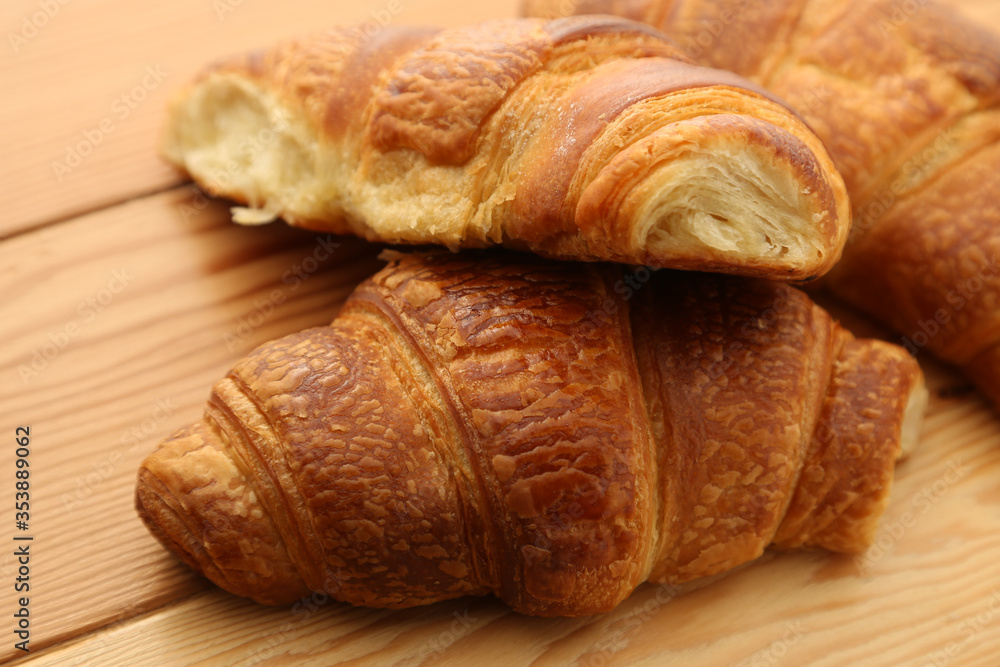 French croissants on a wooden board. 
