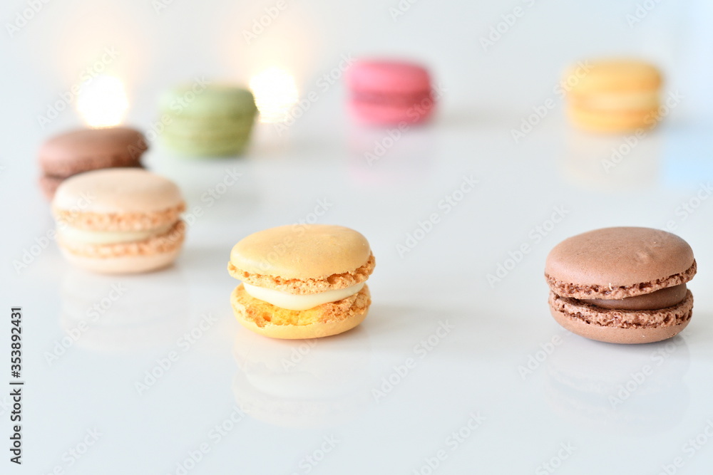 Cake macaron or macaroon on white background, sweet and colorful almond cookies with various pastel colors, vintage look. Different types of macaroons are a delicious dessert.