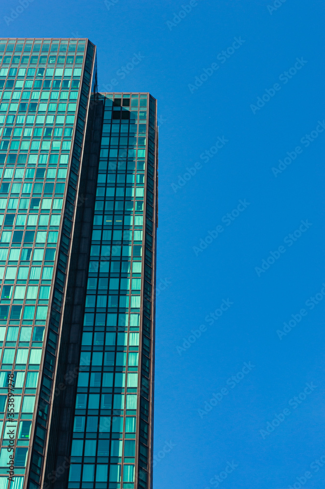 Close shot of a modern skyscraper with abstract reflections in it
