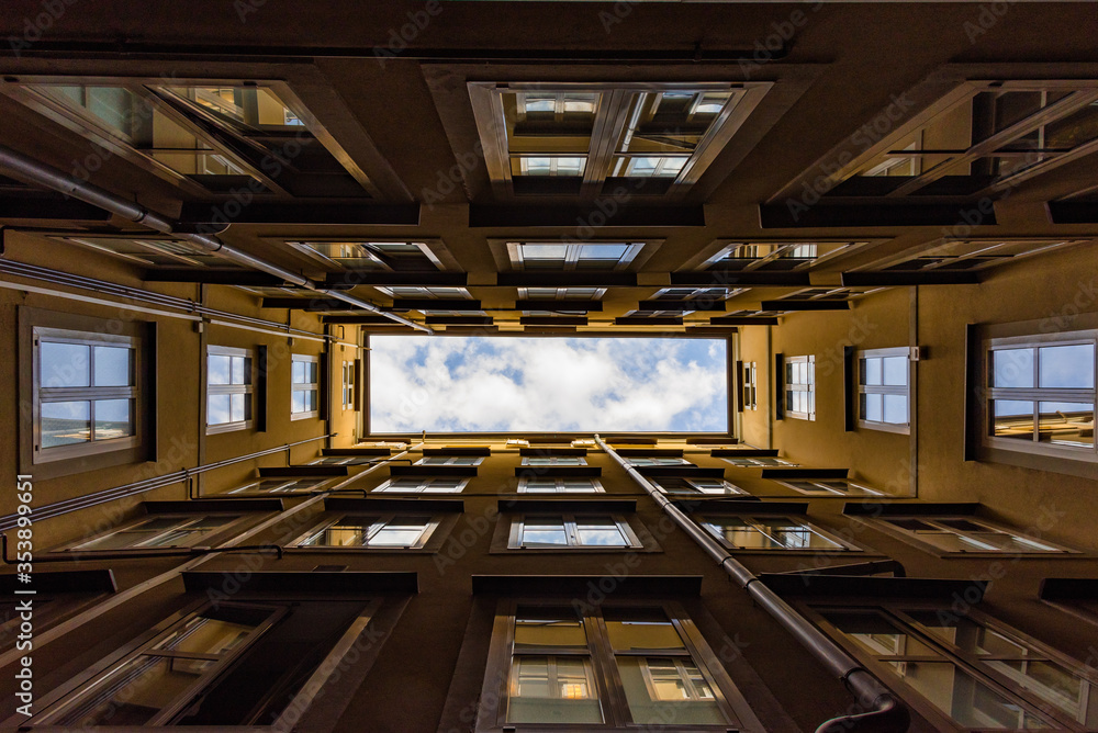 Sky view from the bottom of the courtyard of the building, forming a rectangle view