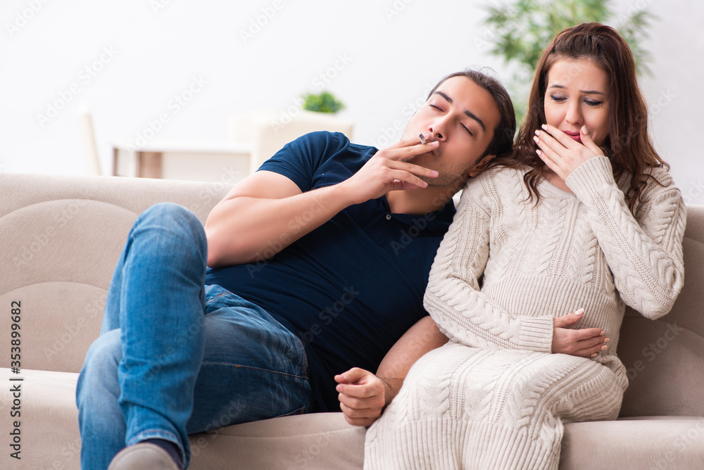 Man and pregnant woman in antismoking concept