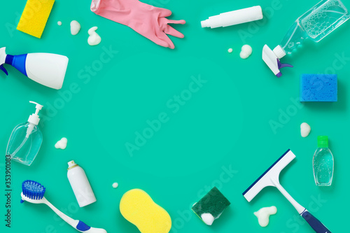 Group of cleaning and disinfection products on green background.