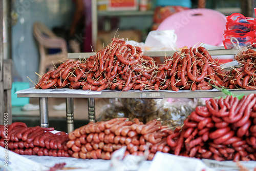 Meat products and street foods on table local shop in Zegyo Market at morning. Mandalay, Myanmar photo