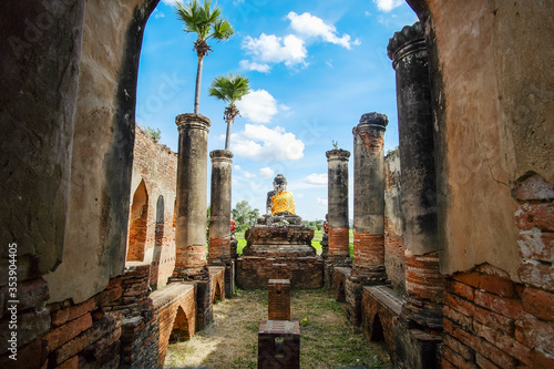 Buddha statue in old temple in Inwa (Ava) near Mandalay in Myanmar (Burma). Southeast Asia travel concepts