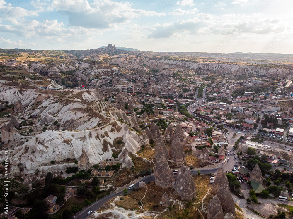 Aerial view of Goreme National Park, Tarihi Milli Parki, Turkey. The typical rock formations of Cappadocia with fairy chimneys and desert landscape. Travel destinations, holidays and adventure
