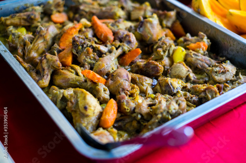 Close up of Filipino style Chicken Curry with coconut milk in stainless steel catering dish. Selective focus.