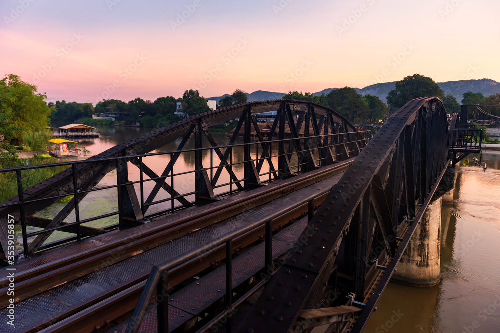 River Kwai bridge with twilight sky at dawn in Kanchanaburi, Thailand. Beautiful view of Railway in early morning. Tourist famous landmark of historic world war2. travel after covid-19 lockdown. River Kwai bridge with twilight sky at dawn in Kanchanaburi, Thailand. Beautiful view of Railway in early morning. Tourist famous landmark of historic world war2. travel after covid-19 lockdown.