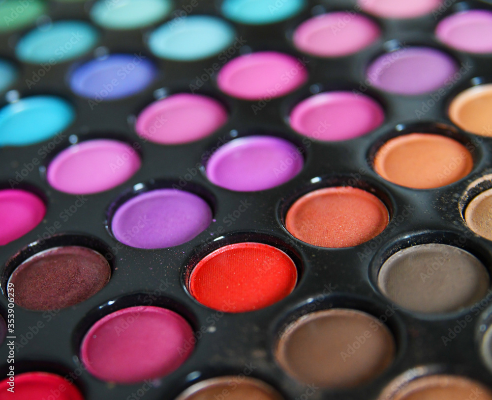 Professional multicolor eyeshadow make up palette background, close-up. Colorful bright eye shadows set backdrop Professional multicolor eyeshadow make up palette background, close-up. Colorful bright eye shadows set backdrop