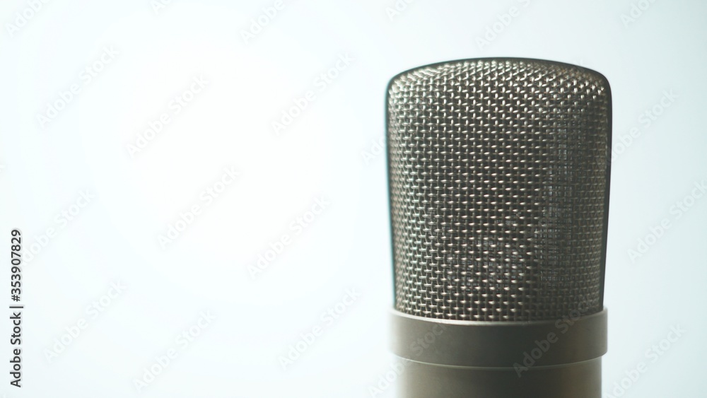 Close up shot of a studio condenser vocal mic grille with membrane - white background Close up shot of a studio condenser vocal mic grille with membrane - white background