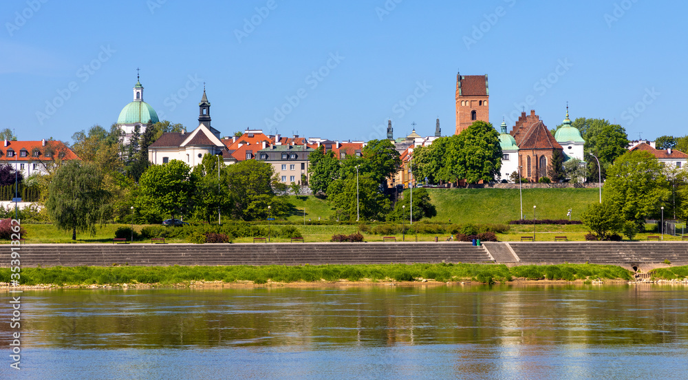 Obraz premium Panoramic view of New Town quarter - Nowe Miasto - and Muranow district with Wybrzerze Gdanskie embankment at Vistula river in Warsaw, Poland