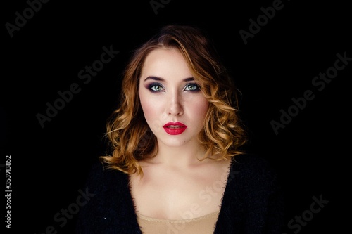 Portrait of gorgeous young woman on dark background. Sensual young woman with red lips and bright makeup. Beautiful healthy face of the young pretty woman with fresh skin.