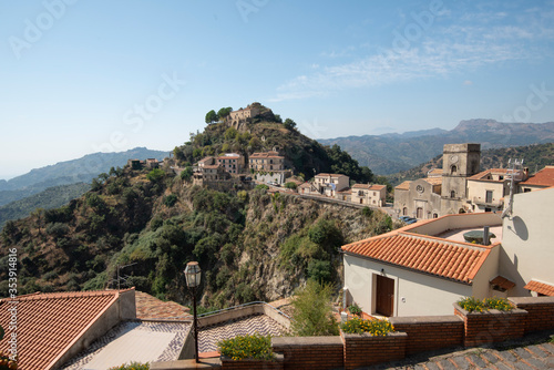 Savoca on a sunny day, with hills and mountains in the distance