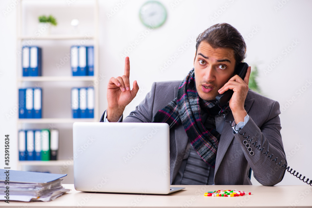 Young male employee suffering at workplace Young male employee suffering at workplace