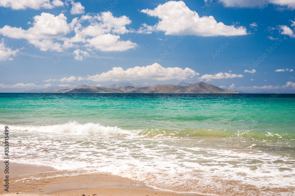 Beautiful golden sand beach with turquoise waters and a island and in the background. Kos island coast, Greece. Dodecanese islands.