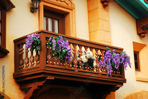Slika na platnu Flowers adorn a fairy tale like balcony