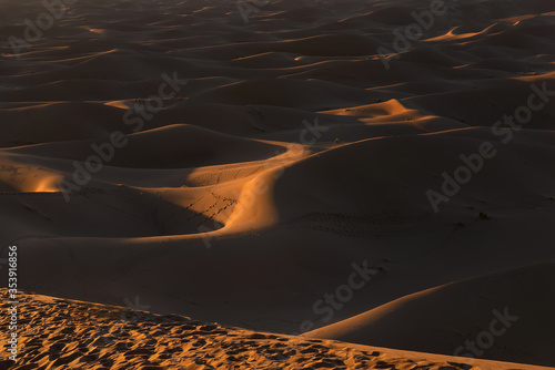 Sunset over Erg Chegaga, Morocco. Erg Chegaga (or Chigaga) is one of two major Saharan ergs in Morocco. This dunes are located in the Souss-Massa-Draa area, 98 km south of the town of Zagora photo