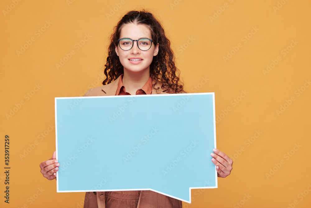 Happy girl with dark long wavy hair holding square blank poster for advert Happy girl with dark long wavy hair holding square blank poster for advert