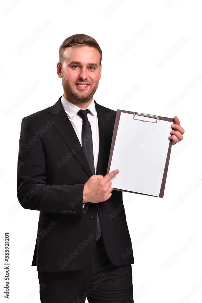 Attractive man in suit holding a blank sheet of white paper and smiling, isolated on white background Attractive man in suit holding a blank sheet of white paper and smiling, isolated on white background