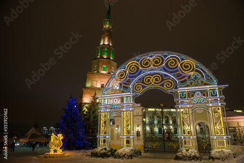 KAZAN, RUSSIA - JANUARY 3 2020: Winter evening in Kazan Kremlin. Gateway to the Presidential Palace and Soyembika Tower with night lights. Kazan, Tatarstan, Russia