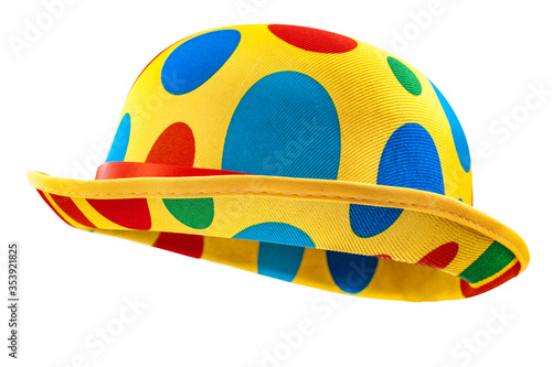 Humorous headgear concept with floating clown bowler hat in red, blue, green and yellow colors  isolated on white background with clipping path cutout using the ghost mannequin technique