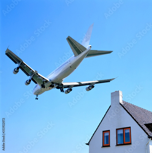 Schiphol runway approach by plane low over houses