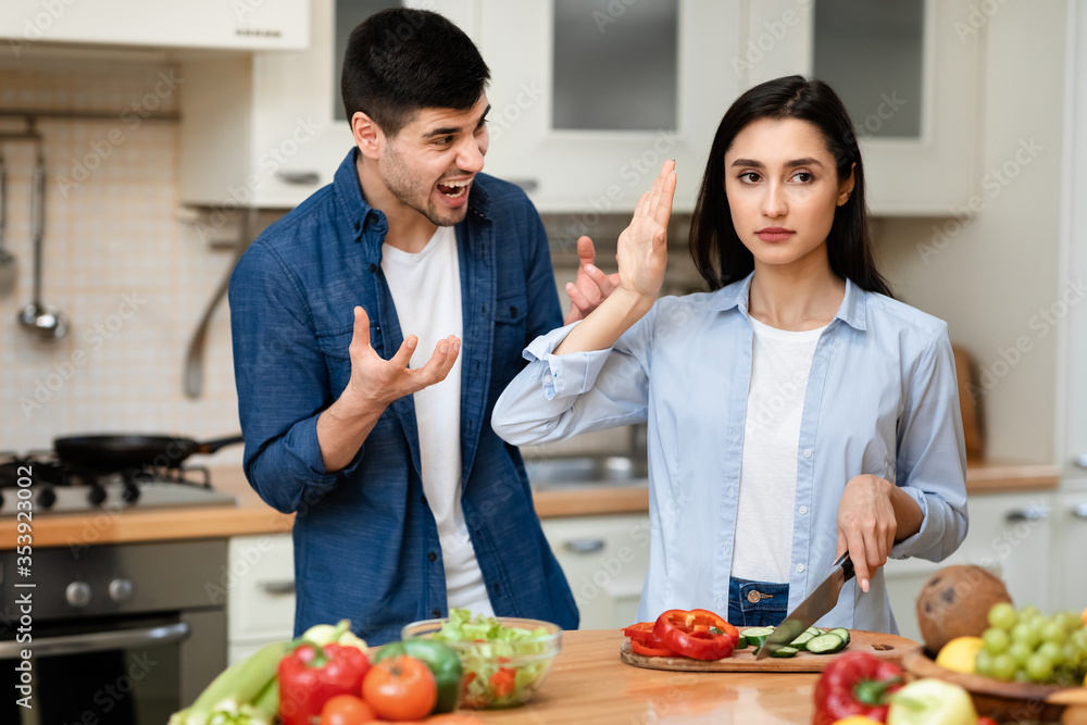 Young couple arguing in the modern kitchen Young couple arguing in the modern kitchen
