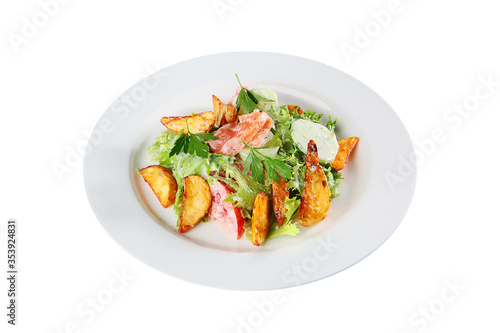 Warm salad of red fish and slices of French fries with vegetables. Copy of the space. Top view. An isolated object.