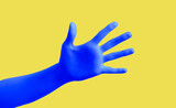 Blue hand gesture on yellow background poster. Open palm and five fingers.