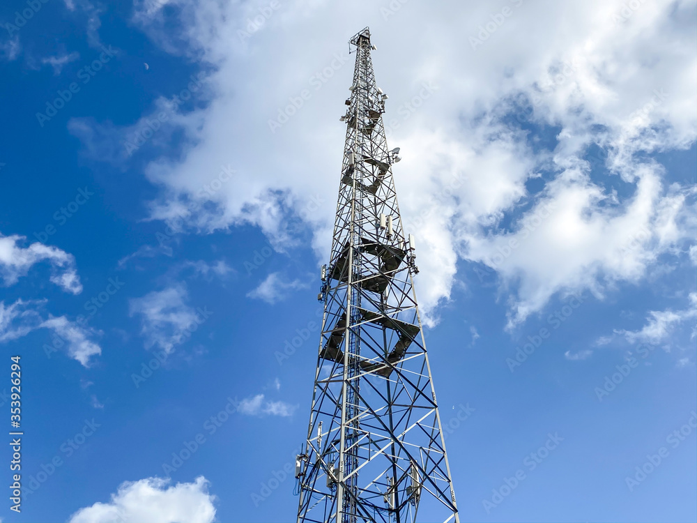 Cellular Base Station or Base Transceiver Station. Telecommunication tower. Wireless Communication Antenna Transmitter. 3G, 4G and 5G Cell Site with blue and cloudy sky. Cellular Base Station or Base Transceiver Station. Telecommunication tower. Wireless Communication Antenna Transmitter. 3G, 4G and 5G Cell Site with blue and cloudy sky.
