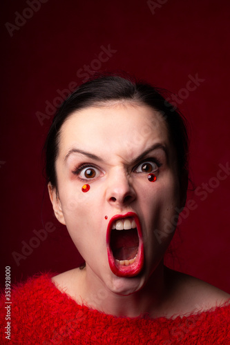 beautiful woman in red with rhinestones on her face