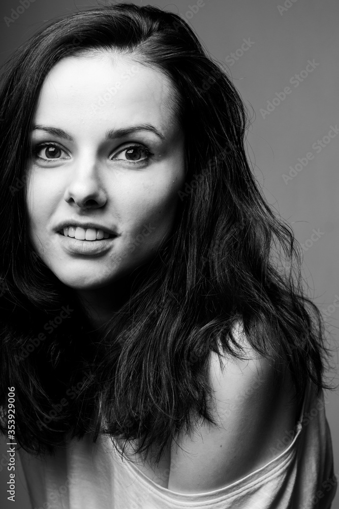 Fototapeta premium beautiful girl in a white T-shirt smiles, laughs. Black and white photography