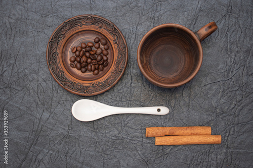 Homemade cup and saucer made of glazed clay. photo