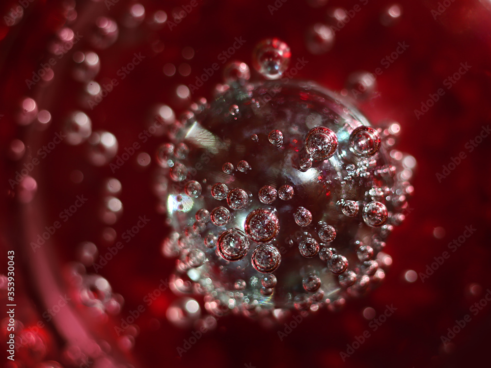 Close-up view of glass transparent crystal glass ball in mineral water.Detail of bubbles in soda water in glass.Soft focus. Close-up view of glass transparent crystal glass ball in mineral water.Detail of bubbles in soda water in glass.Soft focus.