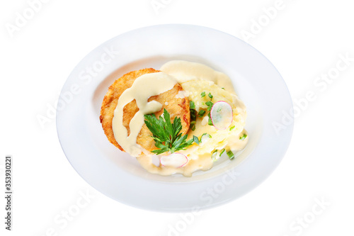 Breaded chicken cutlet with mashed potatoes on a white plate. An isolated object.Top view.