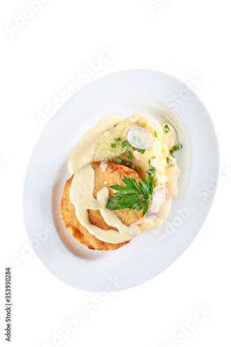 Breaded chicken cutlet with mashed potatoes on a white plate. An isolated object.Top view.