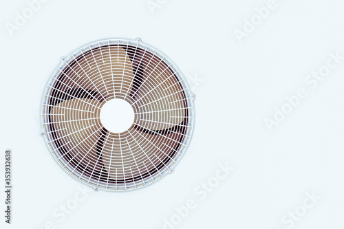 Condenser unit coil fan of an air conditioner. White outer air conditioner device