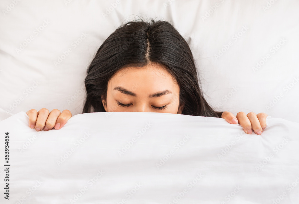 Korean Girl Sleeping Covered With Blanket In Bed Indoor, Top-View Korean Girl Sleeping Covered With Blanket In Bed Indoor, Top-View