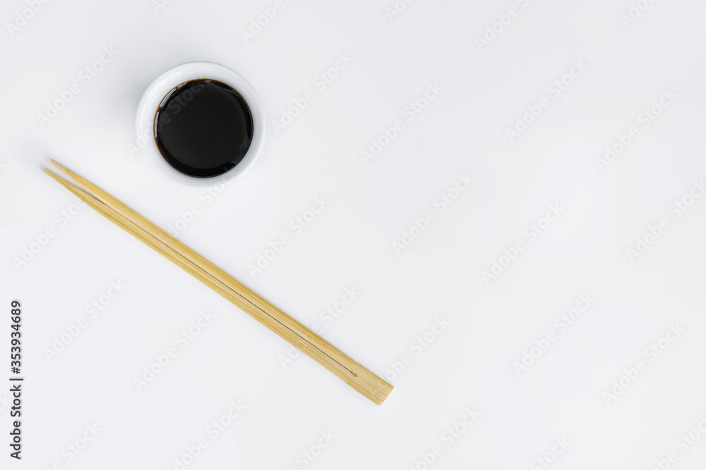Chopsticks and soy sauce on white background (template, open space). Chopsticks and soy sauce on white background (template, open space).