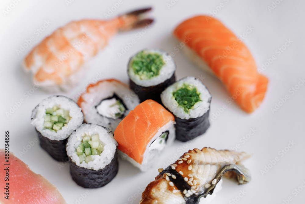 Mix of sushi and rolls close up on white background. Mix of sushi and rolls close up on white background.