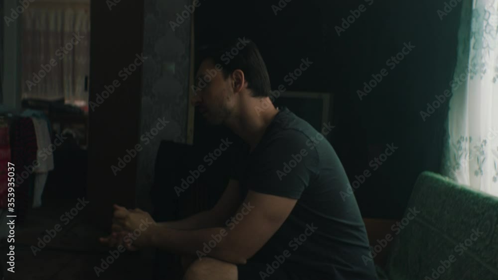man ponders in an old apartment man ponders in an old apartment