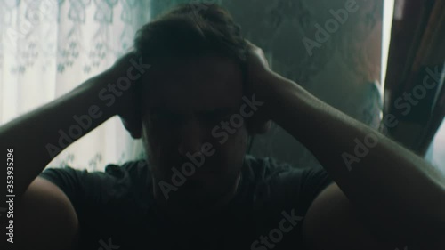 a man has a headache while stay home